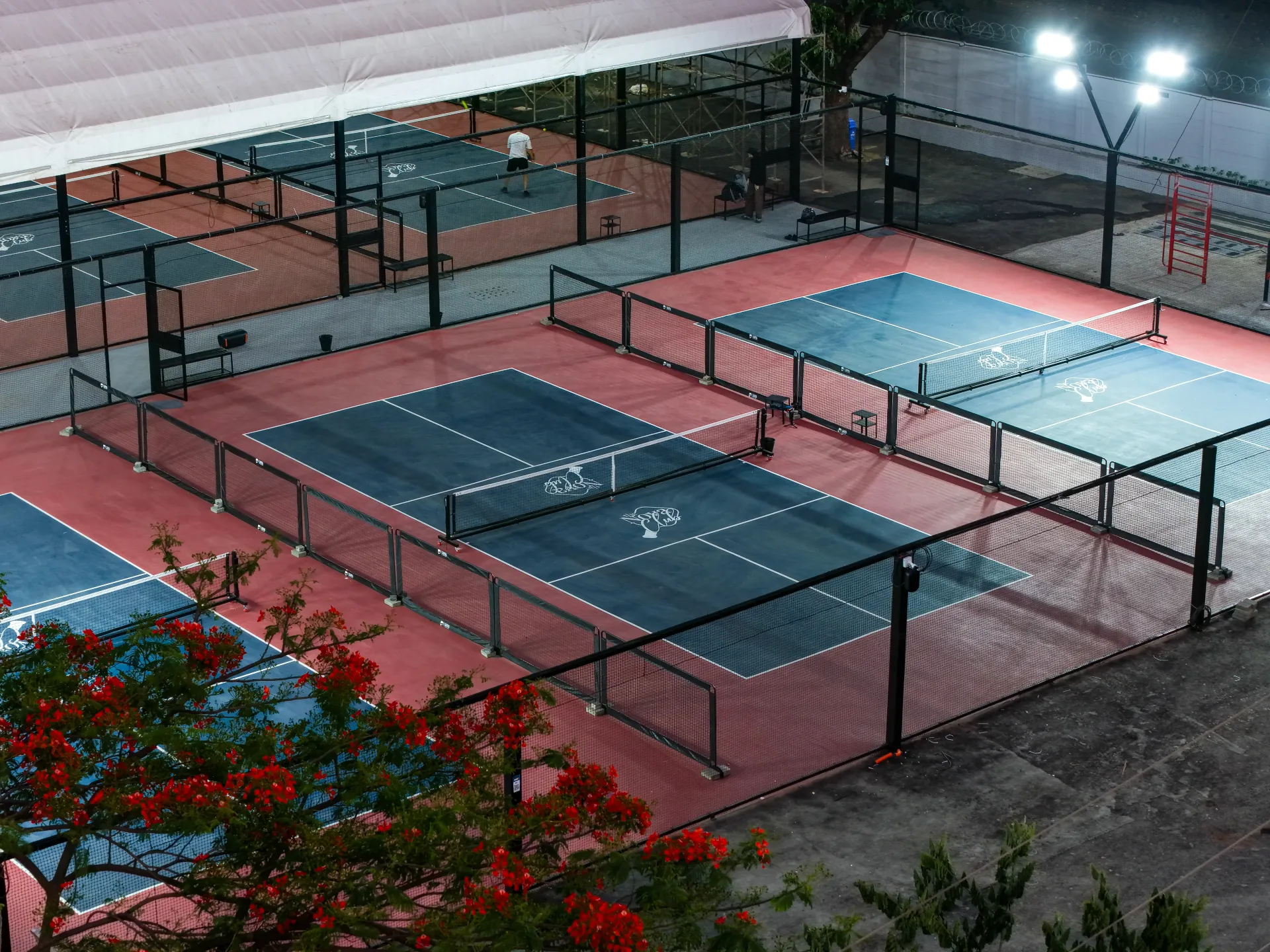 The Nova Club pickleball courts at night in Nashik
